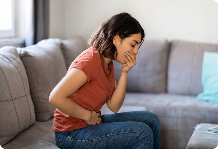 Clinician assessing a patient with stomach illness symptoms